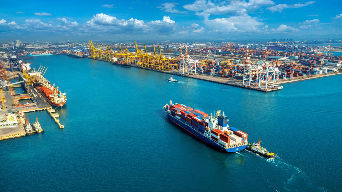 Aerial view of cargo ship and cargo container in harbor.